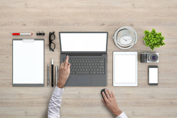 istock Man holding blank tablet knolling overhead view 952755084