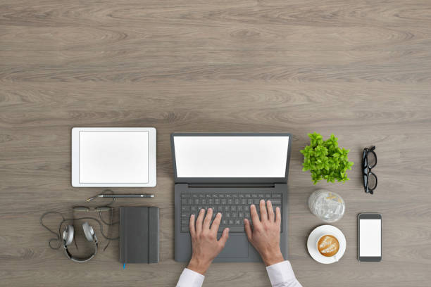 istock Man working on PC laptop knolling overhead view 952755106