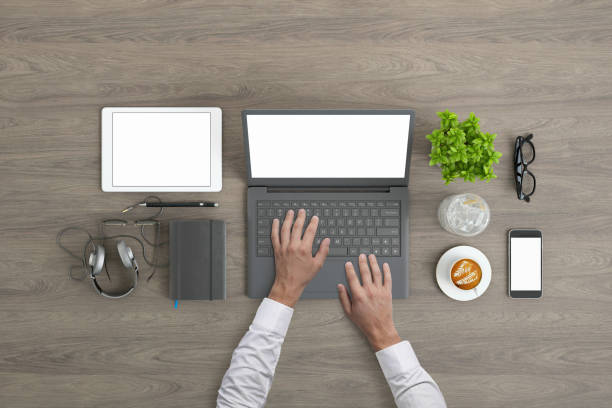 istock Man working on laptop knolling overhead view 952755110