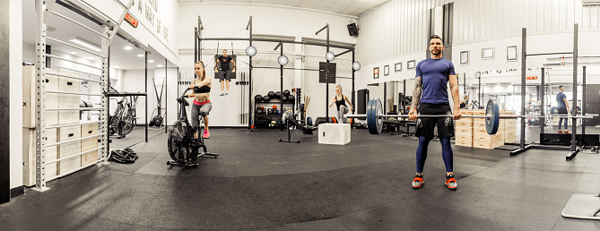 Panoramic View of Fitness Gym with People Exercising.