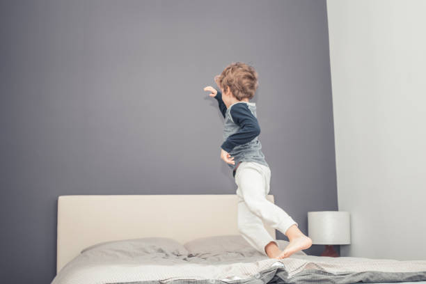istock Carefree boy having fun in bedroom. 952762686