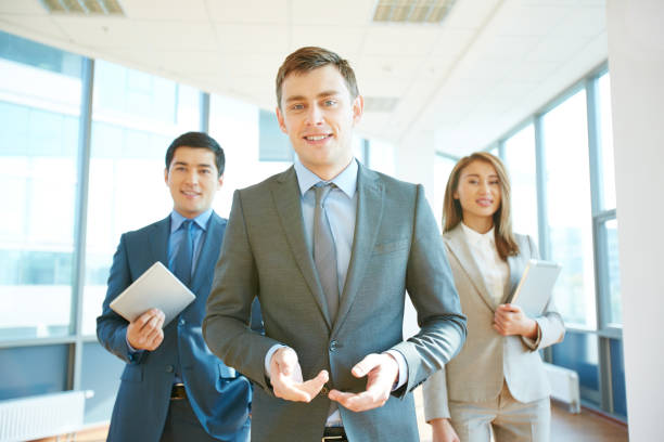 istock Manager standing in front of his team and telling about their company 952763306