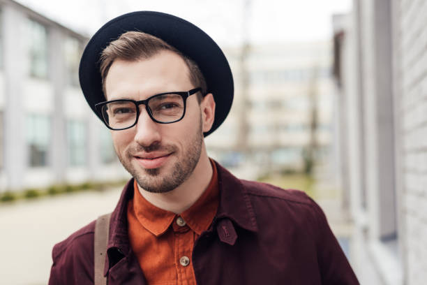 istock handsome smiling young man in trendy hat and eyeglasses 952766232