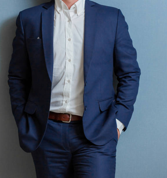 istock Cropped head Man standing in a smart suit 952766382