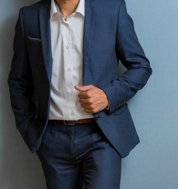 istock Cropped head Man standing in a smart suit 952766716