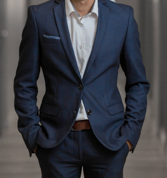 istock Cropped head Man standing in a smart suit 952766774