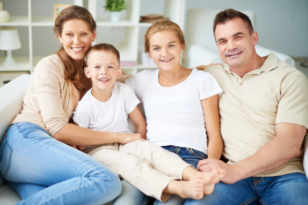 istock Happy family embracing and looking at camera 952769002
