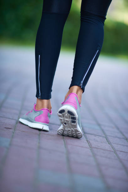 istock Slim female legs in running shoes 952773158