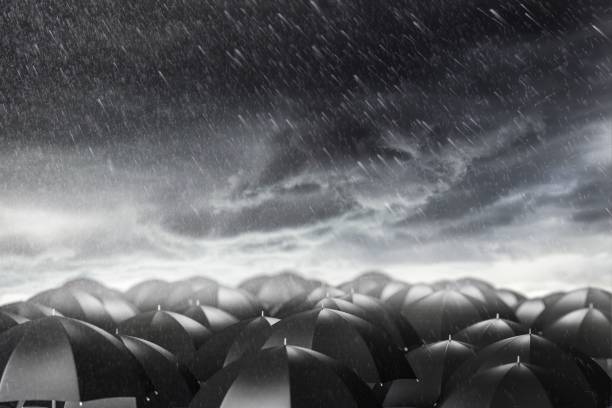 istock Umbrellas in a stormy weather, concept of protection and security 952777092