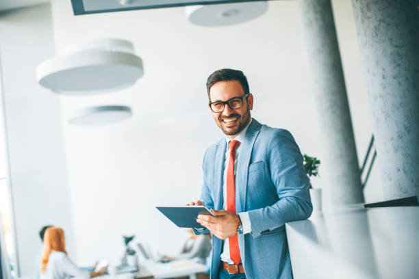 istock Young businessman with digital tablet in office 952777826