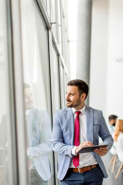 istock Young businessman with digital tablet in office 952777868