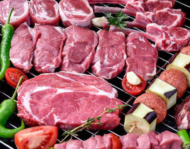 istock Raw mixed red meats on a barbecue 952778804