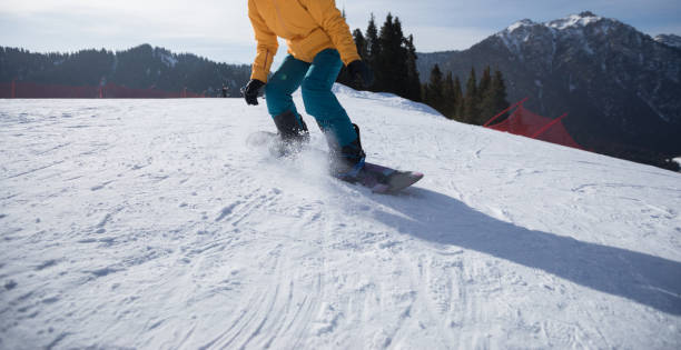 istock Snowboarder snowboarding on winter mountain top 952786936