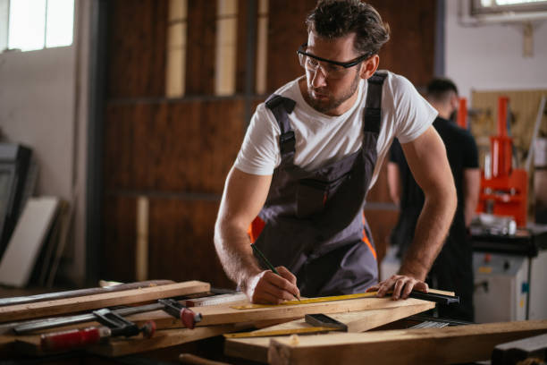 istock Male carpenter measuring the board 952787656