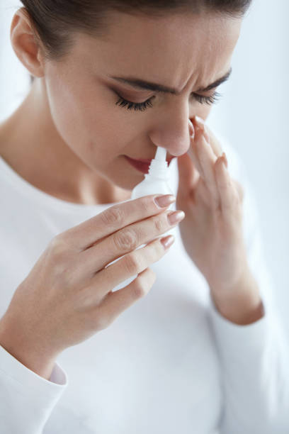 istock Cold. Beautiful Woman Using Nasal Spray 952792998