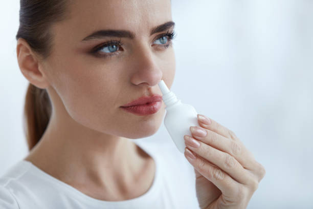 istock Beautiful Woman With Flu Or Cold Using Nasal Spray 952793242