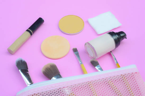 istock Content of cosmetic bag. Lipstick, eye shadows,  brushes for makeup on top view copyspace 952793326