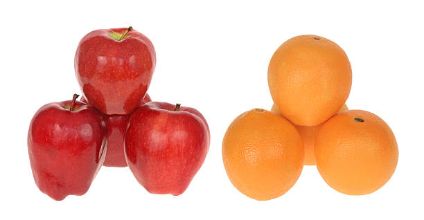comparar manzanas con naranjas - comparison apple orange isolated fotografías e imágenes de stock