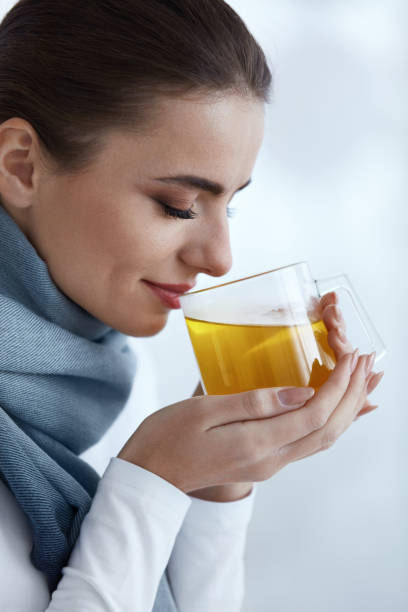istock Beautiful Woman With Hot Drink, Drinking Warming Yellow Drink 952795220
