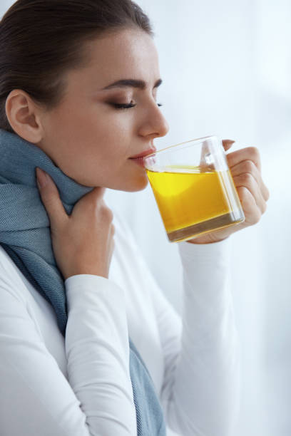 istock Beautiful Woman With Hot Drink, Drinking Warming Yellow Drink 952796126