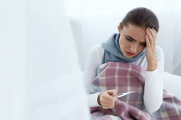 istock Woman Caught Cold, Having Fever And Measuring Temperature 952796558