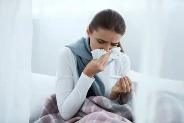 Photo of Woman Caught Cold Or Flu, Sneezing In Wipe And Wiping Nose