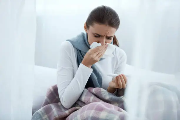 Photo of Woman Caught Cold Or Flu, Sneezing In Wipe And Wiping Nose