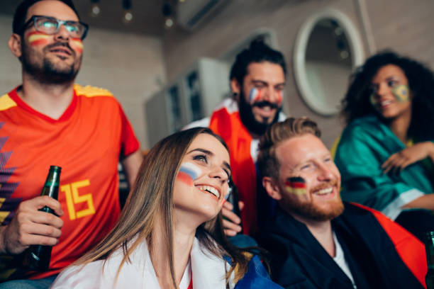 istock Happy friends supporting different national teams watching soccer 952796830