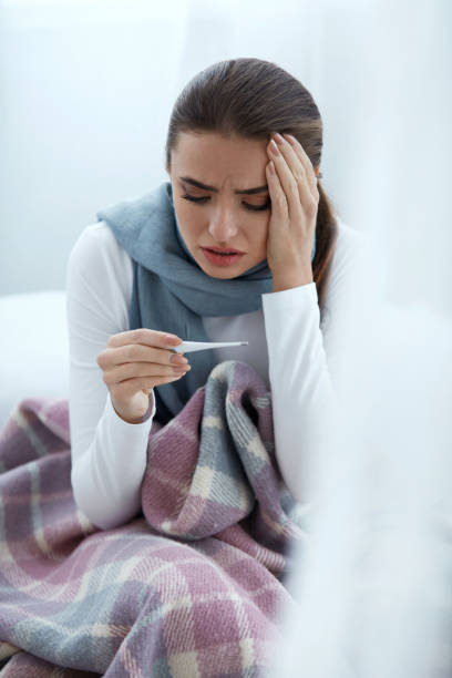 istock Woman Caught Cold, Having Fever And Measuring Temperature 952796864