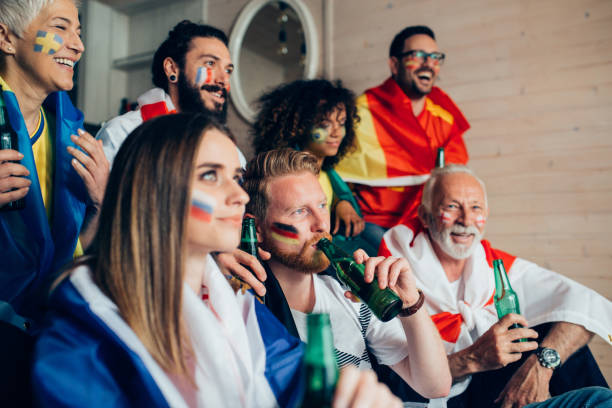 istock Friends with face paint watching soccer and having beer 952796916