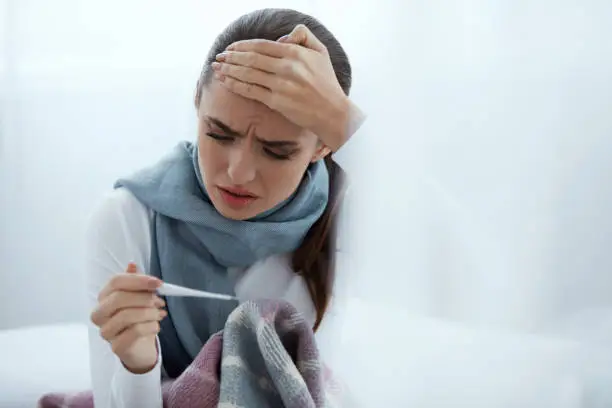 Photo of Woman Caught Cold, Having Fever And Measuring Temperature
