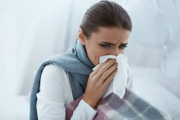 Photo of Woman Caught Cold Or Flu, Sneezing In Wipe And Wiping Nose