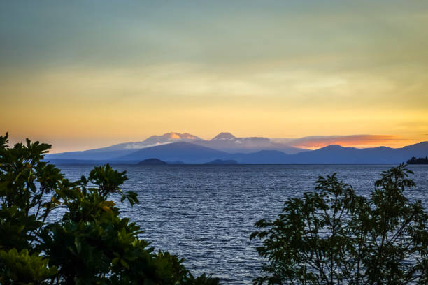 Taupo Lake and Tongariro volcano at sunset, New Zealand Taupo Lake and Tongariro volcano landscape at sunset, New Zealand tongariro national park photos stock pictures, royalty-free photos & images