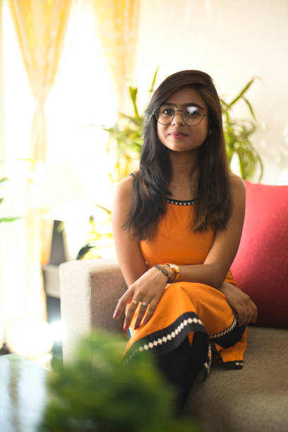 istock Woman sitting on sofa at home 952801380