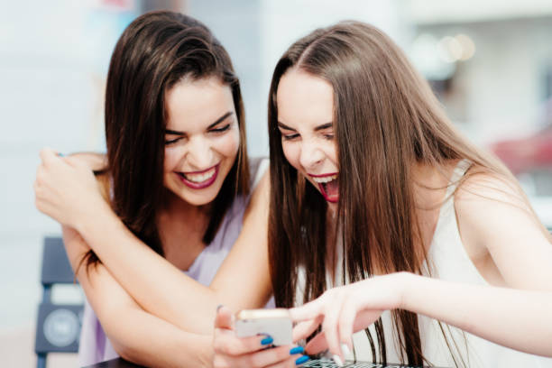 istock Girls have fun with a phone in coffee 952804772
