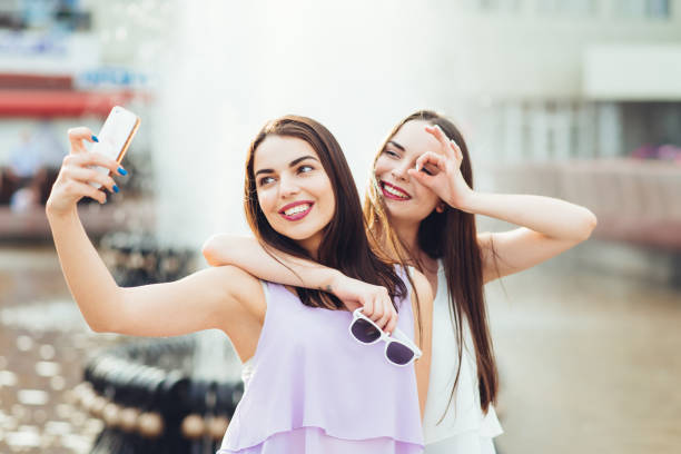 istock Two beautiful sisters do selfie on the street 952808294
