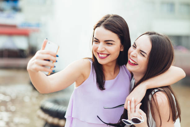 istock Two beautiful sisters do selfie on the street 952809342
