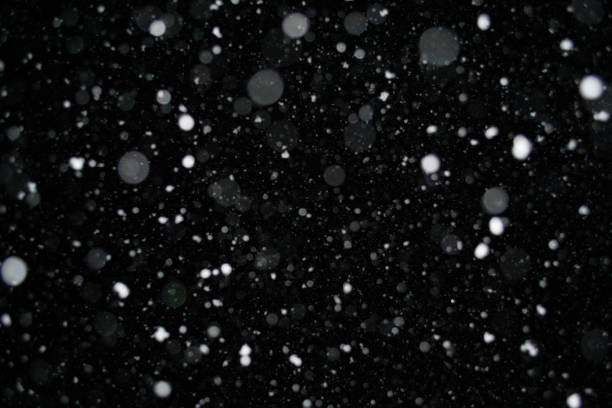 istock Photo of a snow falling at night, beautiful background 952811370