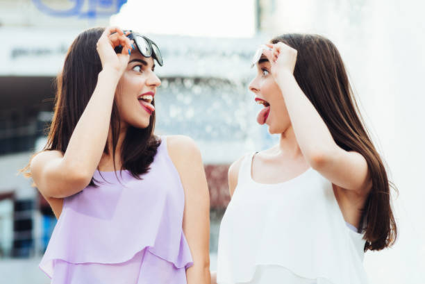 istock Two beautiful girls having fun on the street 952811662