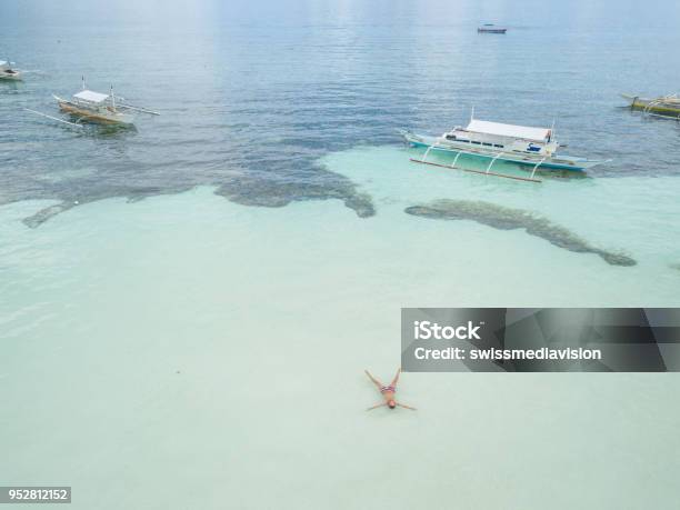 Aerial View Of Man Relaxing In Tropical Sea Like Star Shape Beach Vacations Concept Stock Photo - Download Image Now