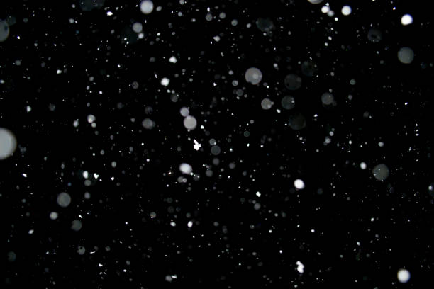 istock Photo of a snow falling at night, beautiful background 952817052
