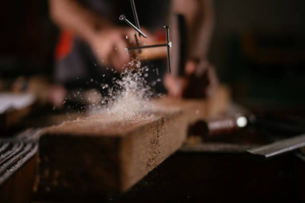 Close up of carpenter working in craft workshop. Shallow DOF. Developed from RAW; retouched with special care and attention; Small amount of grain added for best final impression. 16 bit Adobe RGB color profile.