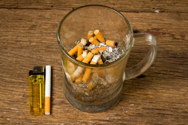 istock glass beer ashtray cigarette on old wood 952817936