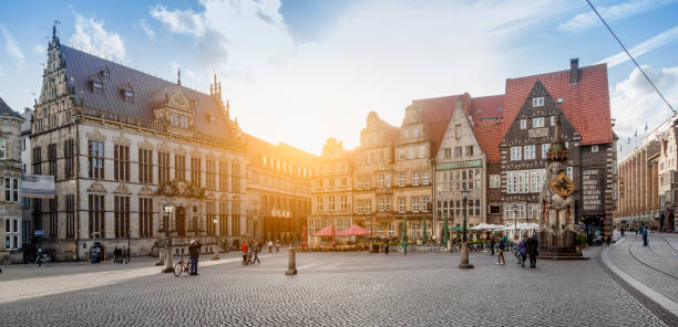 Panoramic view of historical Bremen market square (Bremer Marktplatz) in beautiful golden evening light at sunset, hanseatic city of Bremen, northern Germany