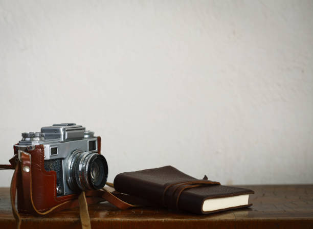 istock vintage stuff. Photo camera, lights, leather note pad on white background 952836032