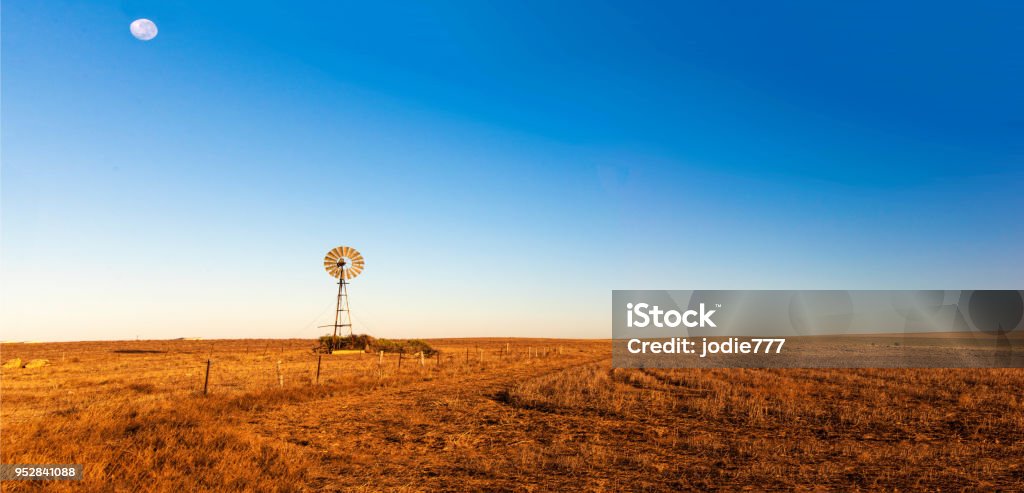 Panoramic view of early morning landscape with a windmill. Australia Stock Photo