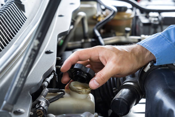 istock Car repair service, Auto mechanic checking oil level in a engine 952844896