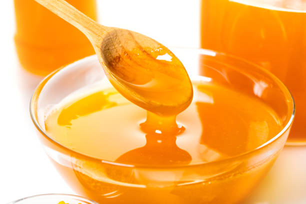 istock organic honey drips from spoon 952845216