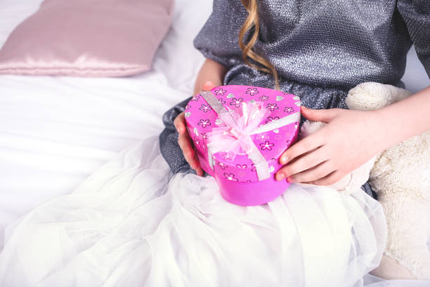istock Young smiling woman holding red gift box 952845554