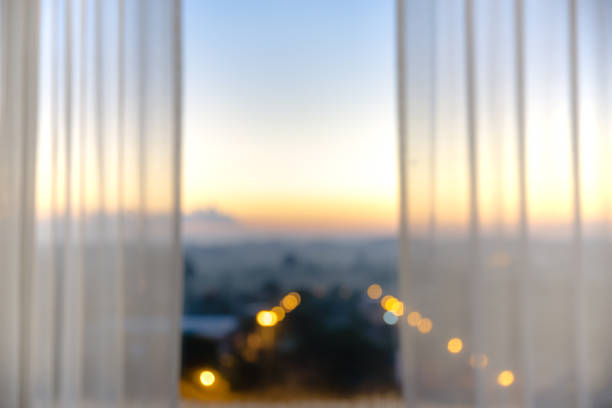 istock Defocused curtain window with sunlight in the early morning. 952855372